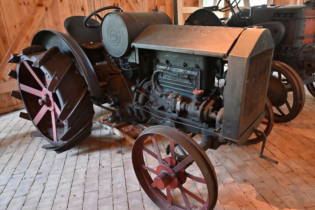 Historický kolový tahač Hanomag s velkými ocelovými paprskovými koly a masivním chladičem motoru.