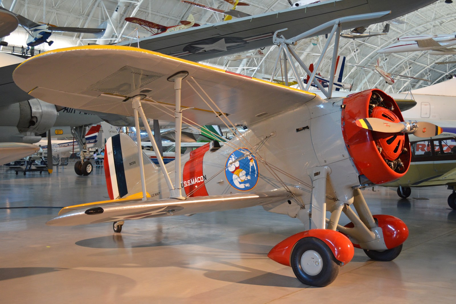 Dochovaný letoun Curtiss F9C Sparrowhawk se záchytným hákem nad křídlem v leteckém muzeu.
